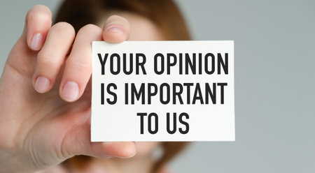 A person holding a white card that says Your Opinion is Important to Us. The person is holding the...