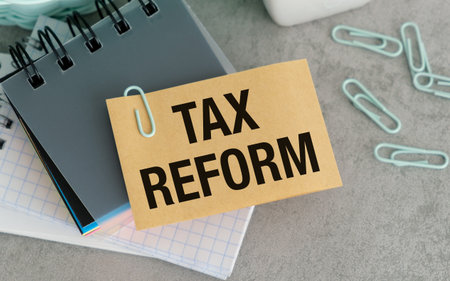 On the table are paper clips, note paper with text - Tax Reform, Business Conceptの写真素材