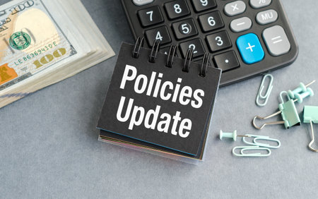 Policies Update note is on top of a calculator and a stack of money, Business Conceptの写真素材