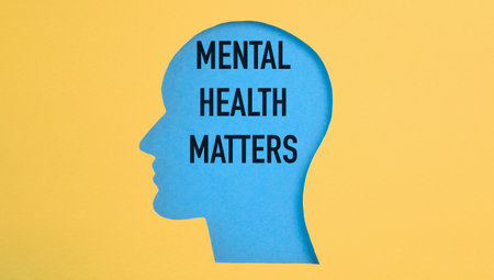 Text Mental Health Matters on the background of a human head figure on a yellow background. Mental health concept.の写真素材