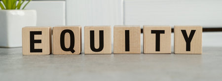 A wooden block with the word Equality written on it. The blocks are arranged in a row, with each block having a different letter. The arrangement of the blocks creates a sense of unity and balanceの写真素材
