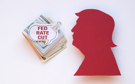 A red paper cutout of a man's face with the words Fed Rate Cut written below itの写真素材