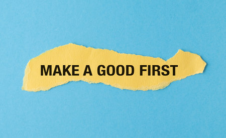 Make a Good First text on yellow with white paper torn ripped of horizontal backgroundの写真素材