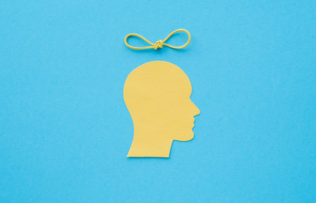 A yellow head with a string tied around it. The head is on a blue background. Panic attack and...