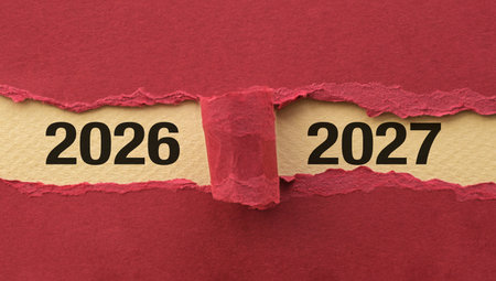 A torn piece of paper with the year 2026 and 2027 written on it. The torn paper suggests that the year is coming to an end and a new one is about to beginの写真素材