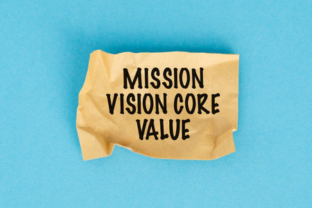 A torn piece of paper with the word Mission Vision Core written on it. The paper is crumpled and has...