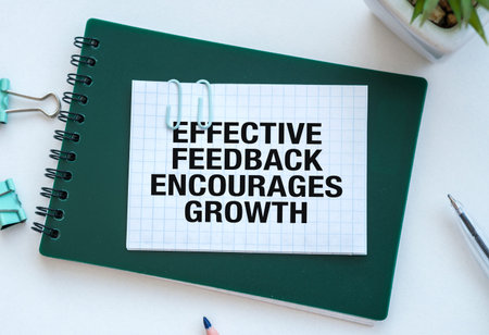 Effective Feedback Encourages Growth text With an Idea Writing on green notepad with pen on white...
