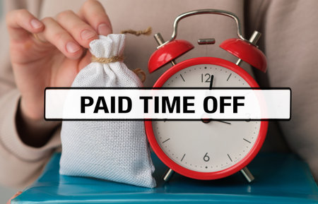 PAID TIME OFF (PTO) text with a red alarm clock and a money bag held by a person for employee benefits and vacation policy concept.の写真素材