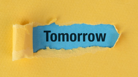 Torn paper reveals bold word Tomorrow against vibrant yellow background. Colorful contrast symbolizes hope, change, and forward progress. Bright tones evoke optimism and fresh beginnings