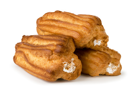 Three eclairs with cream on a white, isolated.