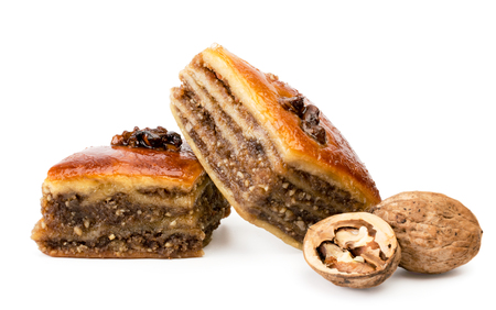 Two pieces of praise and walnuts close up on a white background. Isolated.の写真素材