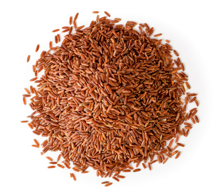 Bunch of red rice on a white. The view from the top.の写真素材