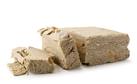 Halva sunflower cut into pieces on a white, close-up. Isolated.の写真素材