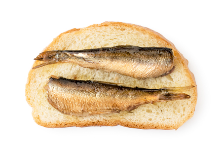 Sprats fish on a piece of bread, sandwich on a white. The form of the top.の写真素材