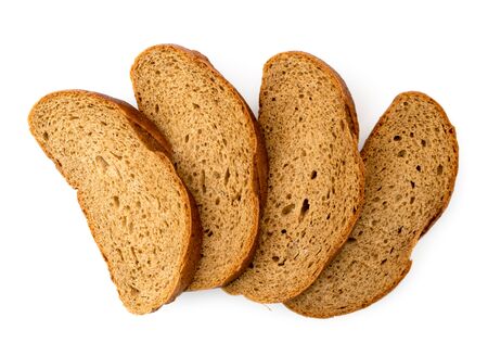 Slices of brown bread on a white. The view of the top.