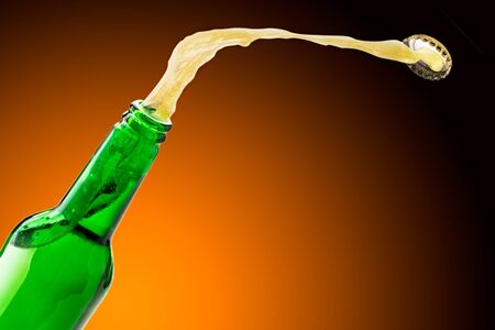 Beer splashes fly off the bottle, background. Place for textの写真素材