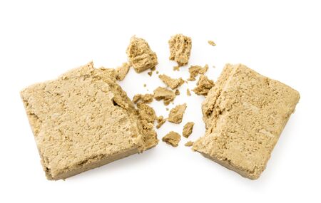 Two halves of the paste with crumbs on white background. The view of the top.