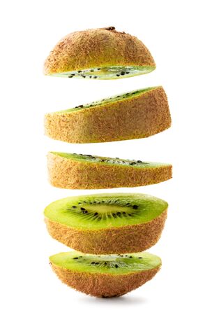 Kiwi cut into pieces flying on a white, isolated.の写真素材