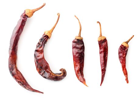 Collection of red dry chili peppers close-up on a white background. The view from topの写真素材
