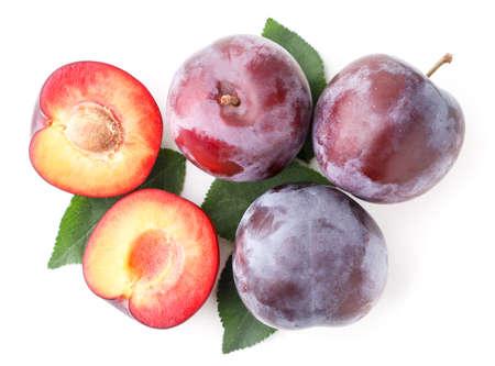 Ripe plums with leaves on a white. Top view
