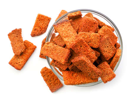 Rye croutons in a plate close up isolated. The view from top