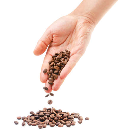 Coffee beans falling from the hand close-up on a white background. Isolatedの写真素材