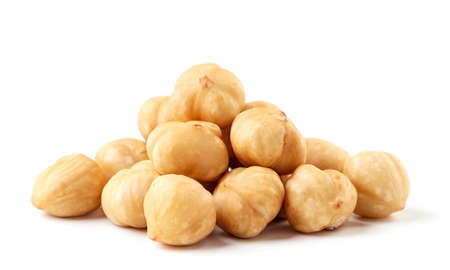 Heap of roasted hazelnuts close-up on a white background. Isolatedの写真素材