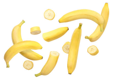 Whole bananas and slices are flying close-up on a white background. Isolatedの写真素材