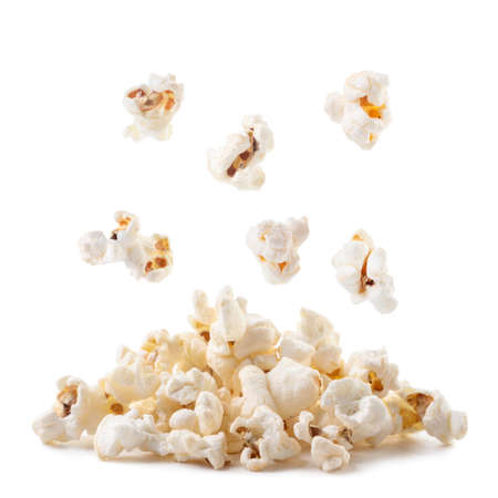 Popcorn falls on a heap close-up on a white background. Isolatedの写真素材