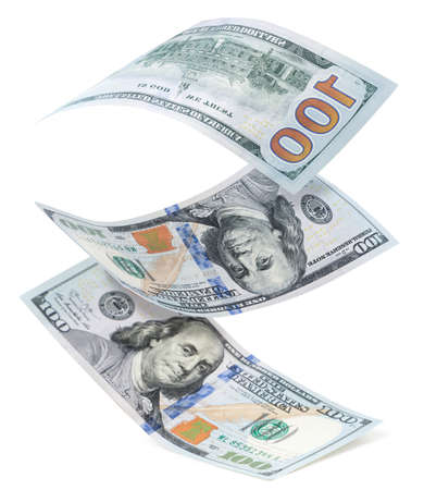 One hundred dollars bills falling close-up on a white background. Isolated