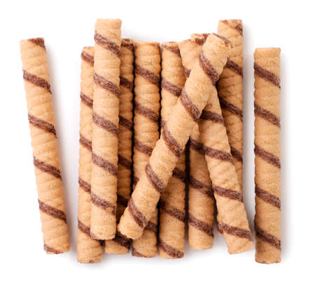 Striped wafer rolls with chocolate close-up on a white background. Top viewの写真素材