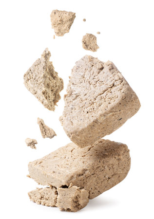 Halva broken into pieces falls on a white background. Isolatedの写真素材