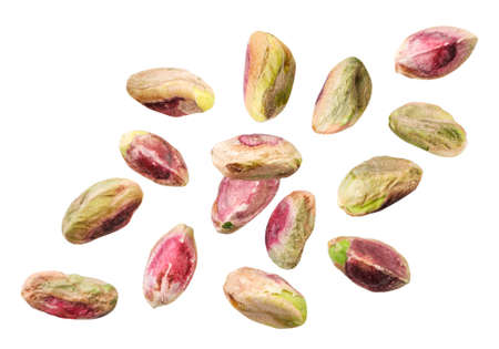 Peeled pistachios fall close-up on a white background, levitating cut pistachios. Isolatedの写真素材