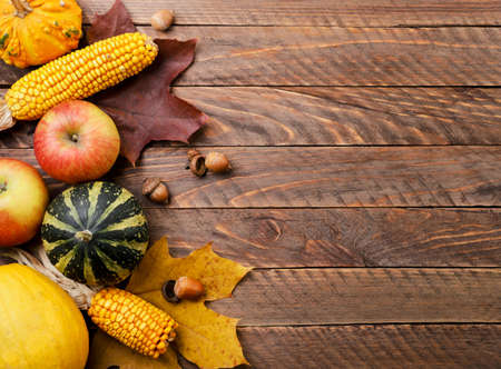 Harvest with autumn leaves close-up on a wooden background, copy space. Autumn background, top viewの写真素材
