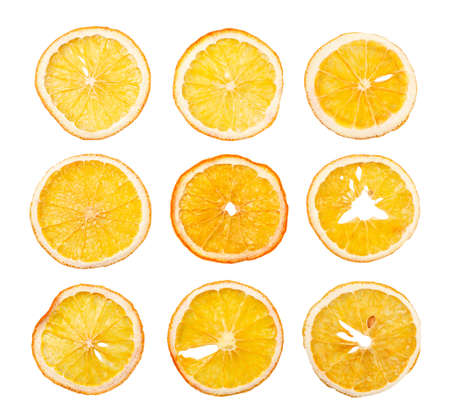Dried orange slices set close-up on a white background, isolated fruit chips. Top view