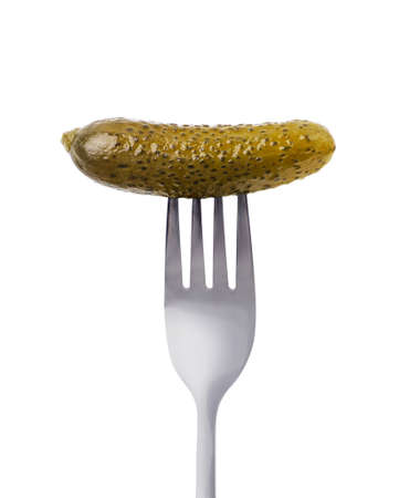 Pickled cucumber on a fork close-up on a white background. Isolatedの写真素材