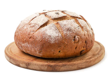 Round bread on a wooden kitchen board close-up on a white background. Isolated