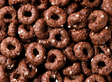 Dry breakfast rings chocolate closeup background. top view