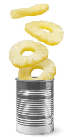 Pineapple rings fly out of a tin can close-up on a white background. Isolated