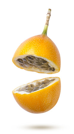 Ripe granadilla broken in half flies close-up on a white background. Isolatedの写真素材