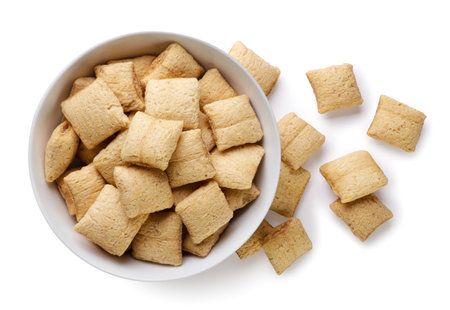 Corn pads in a plate and scattered close-up on a white background. Top viewの写真素材