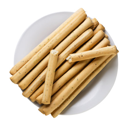 Grissini sticks in a plate close-up on a white background. Top view