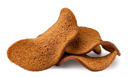 A pile of dried bread close-up on a white background. Isolated
