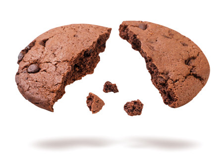 Chocolate chip cookie broken in half flying close-up on white background. Isolatedの写真素材