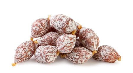 A pile of mini sausages close-up on a white background. Isolatedの写真素材