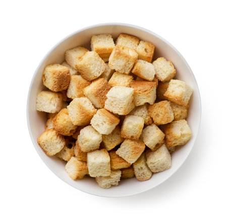 Bread croutons in a bowl on a white background. Top viewの写真素材