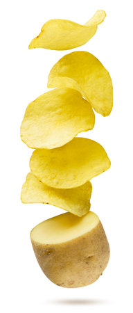 Potato chips flying out of a raw potato close-up on a white background. Isolatedの写真素材