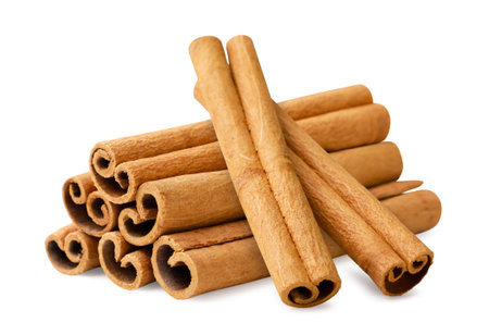 A pile of cinnamon sticks close-up on a white background. Isolated