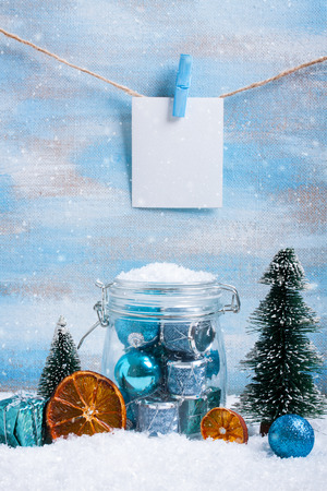Christmas composition with blue decorations, christmas tree, dry orange, blue gift box and place for text or photo.の写真素材
