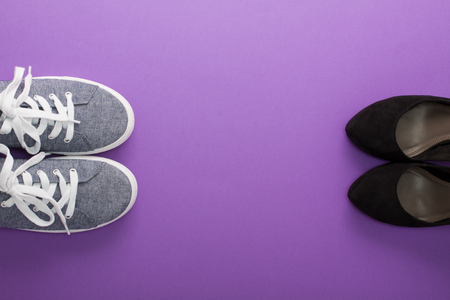 Comfort sneakers vs high heel fashion shoes on a purple background. Fashion blog concept, top view, place for copy 


space.の写真素材